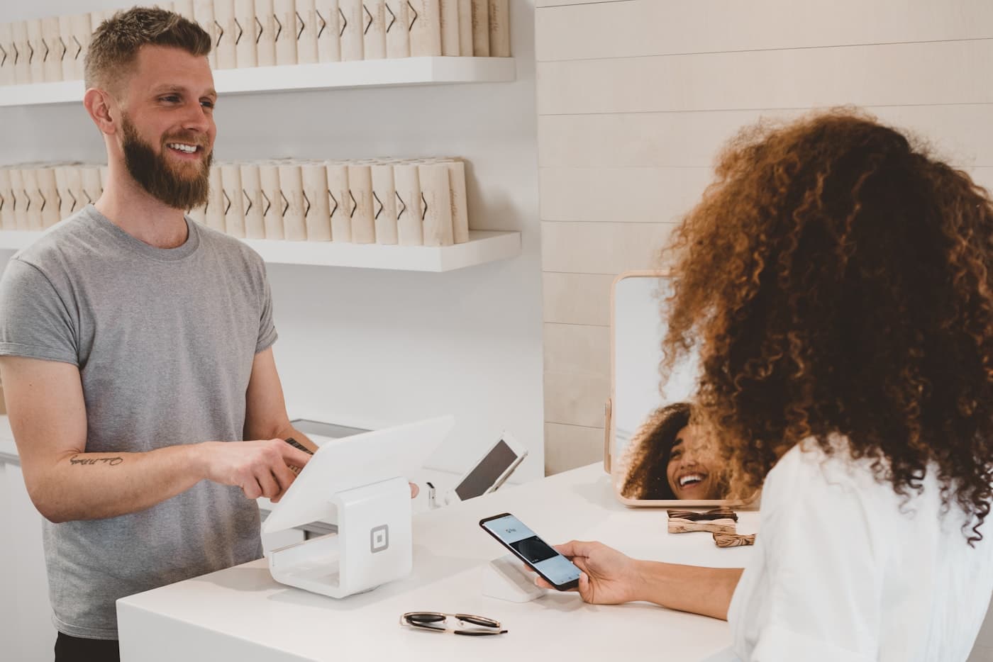 A customer completing a digital payment at a modern point-of-sale counter